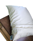 Organic pillowcases made from 100% GOTS certified cotton, shown in soft beige on a wooden surface.