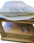 Organic pillowcase on a decorative wooden table, 100% cotton, GOTS certified, made in the USA.