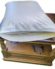 Organic cotton pillowcase on a wooden table.