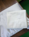 Organic cotton pillowcases on a wooden surface, highlighting their soft and smooth finish.