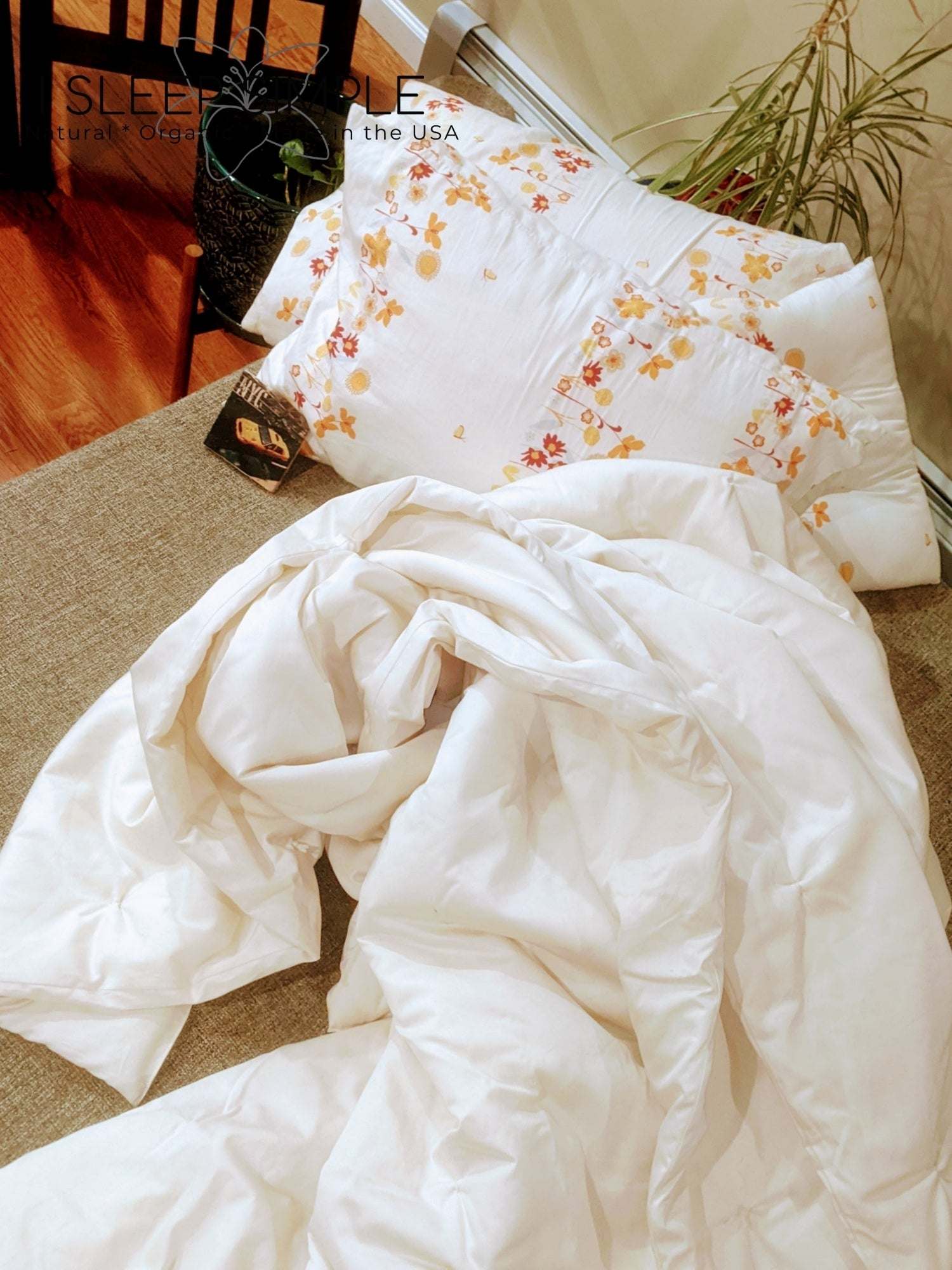 Handmade wool duvet on bed, temperature-regulating, moisture-wicking, hypoallergenic, sustainable.