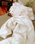 Handmade wool duvet on bed, temperature-regulating, moisture-wicking, hypoallergenic, sustainable.