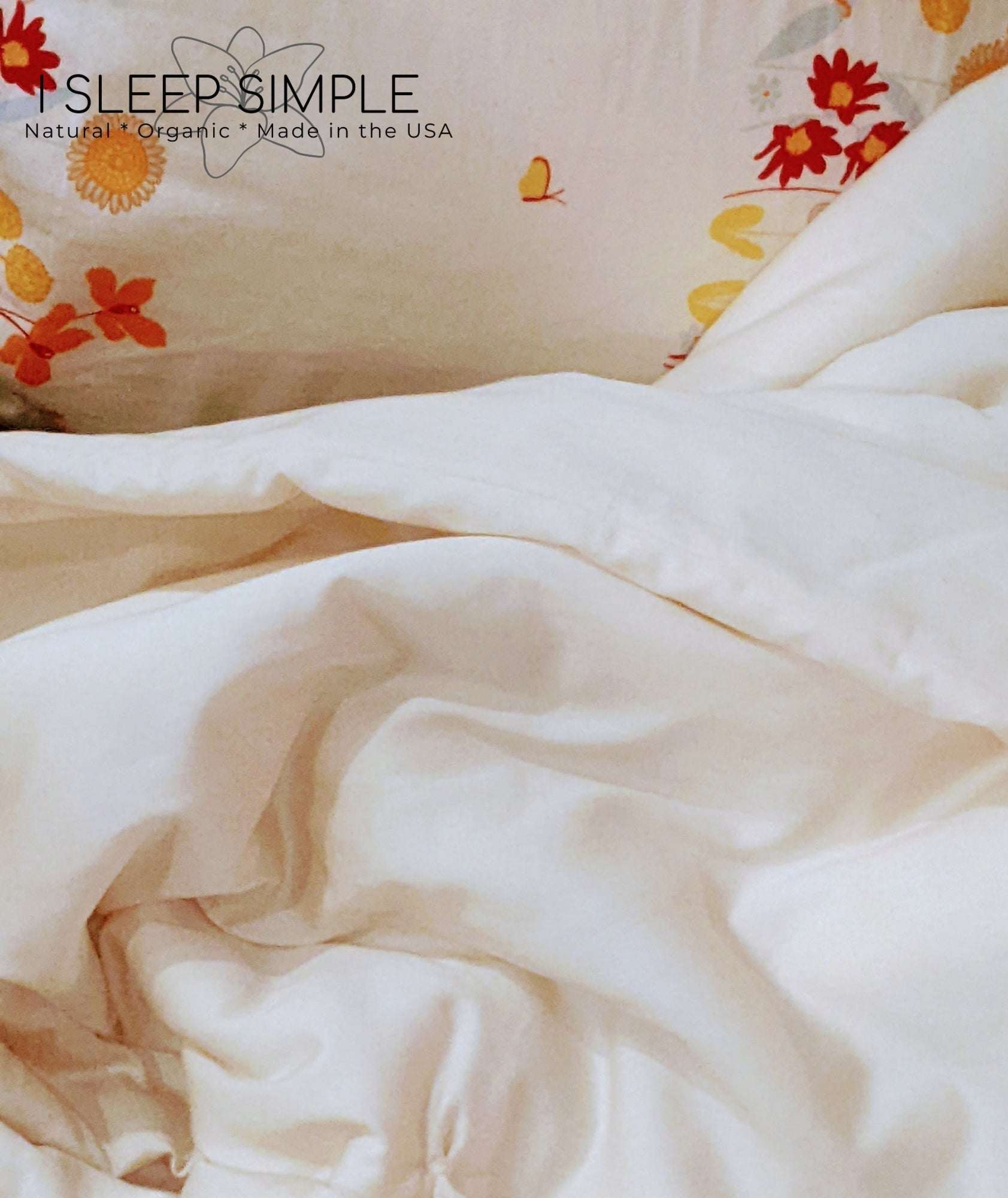 Organic cotton duvet on a floral bedspread, showcasing soft, eco-friendly comfort.