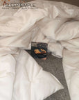 Handmade wool duvet made from New Zealand wool, eco-friendly and hypoallergenic, shown draped on a bed.