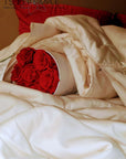 Luxurious organic cotton duvet on a bed, featuring eco-friendly, breathable fabric for all-season comfort.