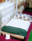 Firm organic cotton and wool shikibuton displayed on floor, illustrating its compact and eco-friendly design.