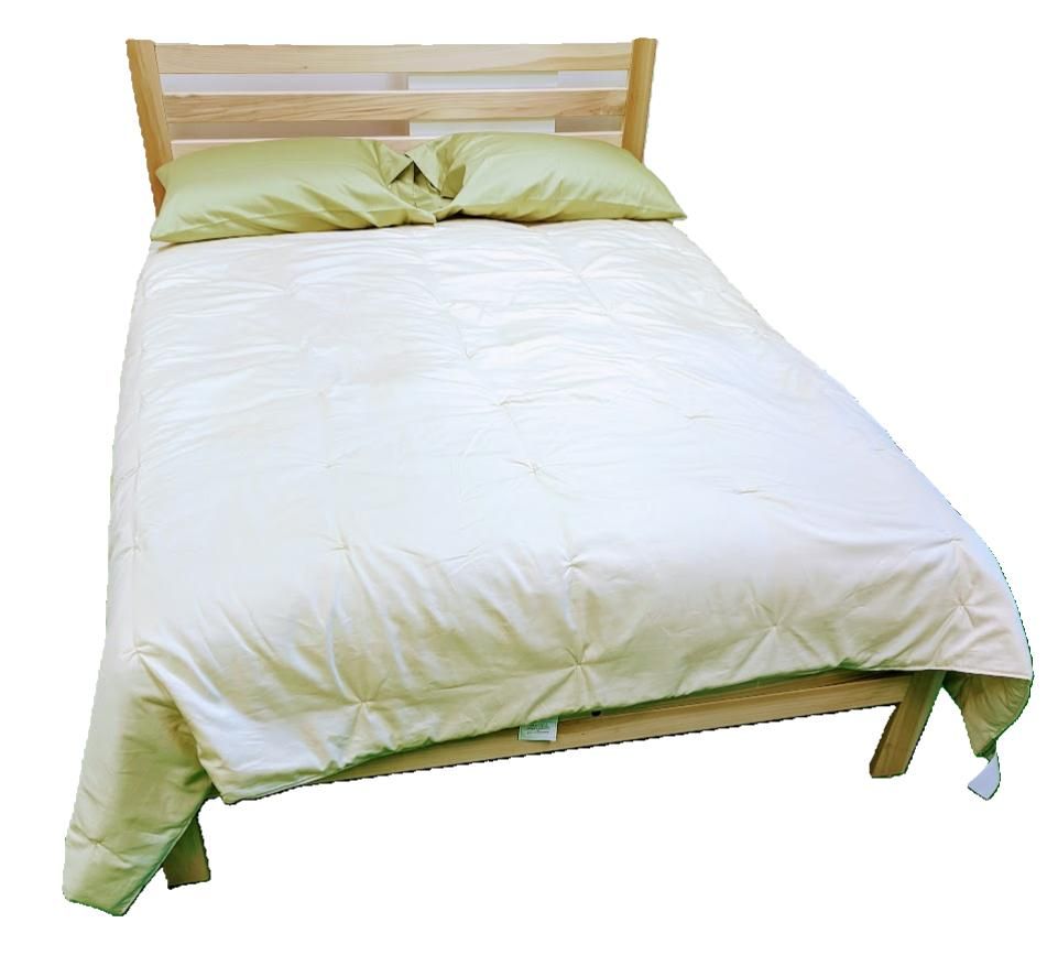 Eco-friendly organic cotton duvet on a wooden bed frame.
