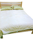 Eco-friendly organic cotton duvet on a wooden bed frame.