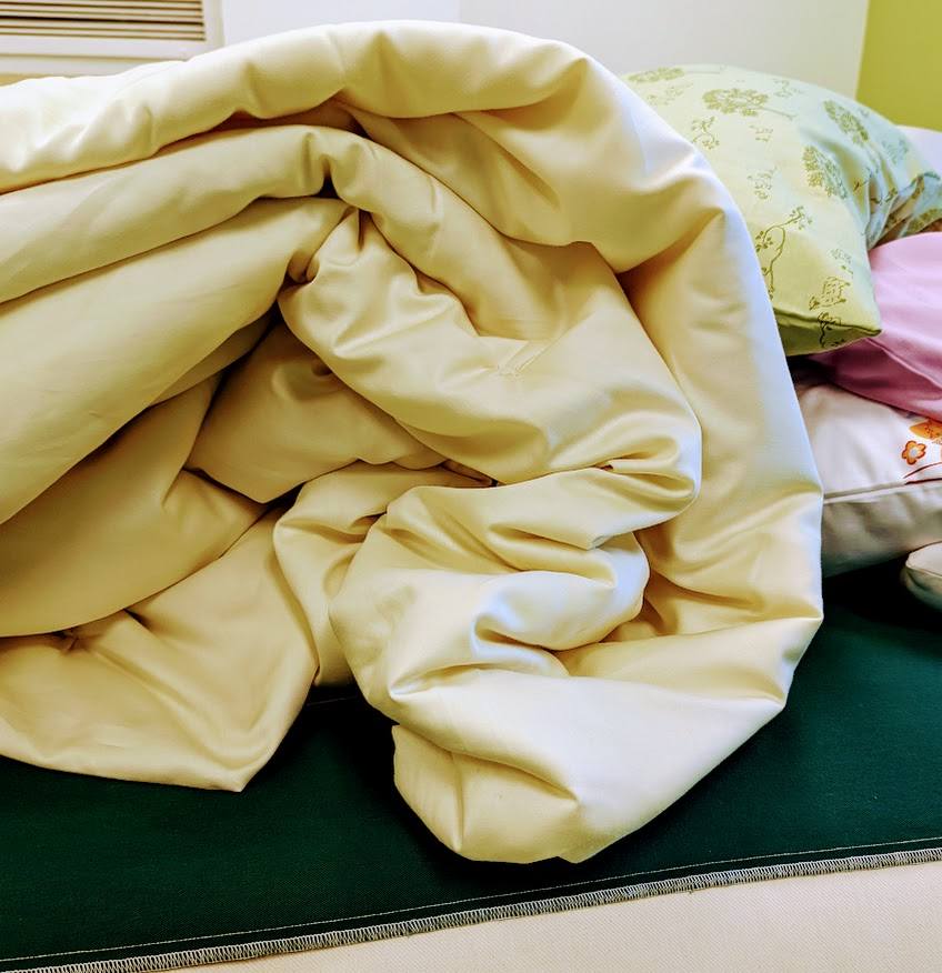 Handmade wool duvet, eco-friendly bedding made from New Zealand wool, USA-crafted for luxury sleep.