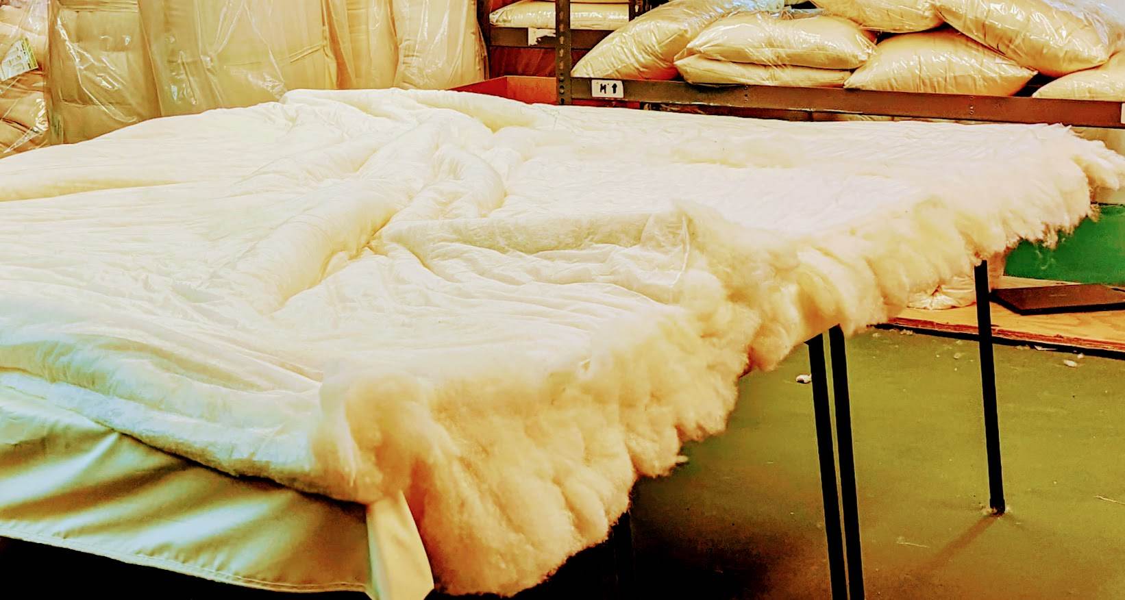 Handmade organic cotton duvet in production, showcasing plush, eco-friendly comfort.