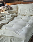 Organic pillowcases on a bed with cotton sheets, 100% cotton, GOTS certified, made in the USA.