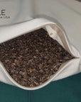 Organic buckwheat pillow with adjustable zipper for customizable comfort and support.