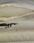Buckwheat and wool pillow showing inner materials with zippers open, highlighting organic and breathable features.