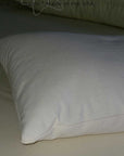 Buckwheat and wool pillow on a bed, showcasing natural, organic materials for supportive and luxurious sleep.