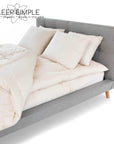 Kapok pillow on a modern grey bed, showcasing soft, sustainable, eco-friendly comfort for all sleeping positions.