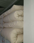 Cotton mattress topper stacked, handmade in USA, available in 2" and 4" thickness for plush comfort.