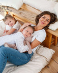 Family relaxing on a bed with a cotton mattress topper, showcasing natural comfort and luxury.