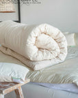 Cotton Mattress Topper rolled on bed, offering plush comfort and breathability.