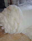 100% virgin wool batting roll, undyed and untreated, perfect for pillows, duvets, and insulation.