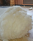 100% virgin wool batting roll, untreated and un-dyed, ideal for insulation, quilting, and more.