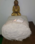 Firm organic cotton and wool futon mattress with a decorative statue on top, GOTS certified, natural and handcrafted.