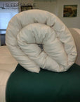 rolled organic cotton mattress topper on bed, handmade in USA for plush natural comfort