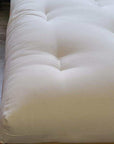 GOTS certified organic cotton and wool futon mattress on wooden frame.