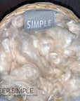 Kapok Fiber in a basket showcasing its natural, silky texture, perfect for eco-friendly, vegan fillings.