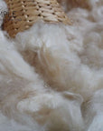 Kapok fiber in a woven basket, showcasing its natural, silky texture; ideal for eco-friendly, vegan filling.