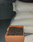 Buckwheat pillow with natural hulls and organic cotton cover for ergonomic support and breathability.