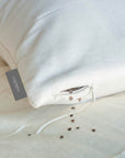 Organic buckwheat pillow with adjustable loft and firmness, designed for ergonomic support and breathability.