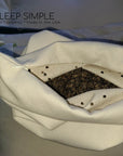 Buckwheat Pillow open to reveal natural buckwheat hulls for ergonomic support.