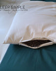 Buckwheat and wool pillow with open pocket showing buckwheat hulls for firm support and wool for plush comfort.