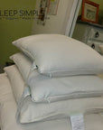 Buckwheat and wool pillows stacked in a cozy setting showcasing natural and organic materials.