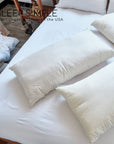 Luxury Best Kapok Pillow on a bed, eco-friendly sustainable comfort with organic cotton cover.