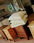 Best Kapok Pillow stacked on wooden furniture in a modern kitchen setting, showcasing natural and organic materials.