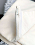 Organic cotton pillow cover with zipper closure, showcasing soft texture and sleek design.