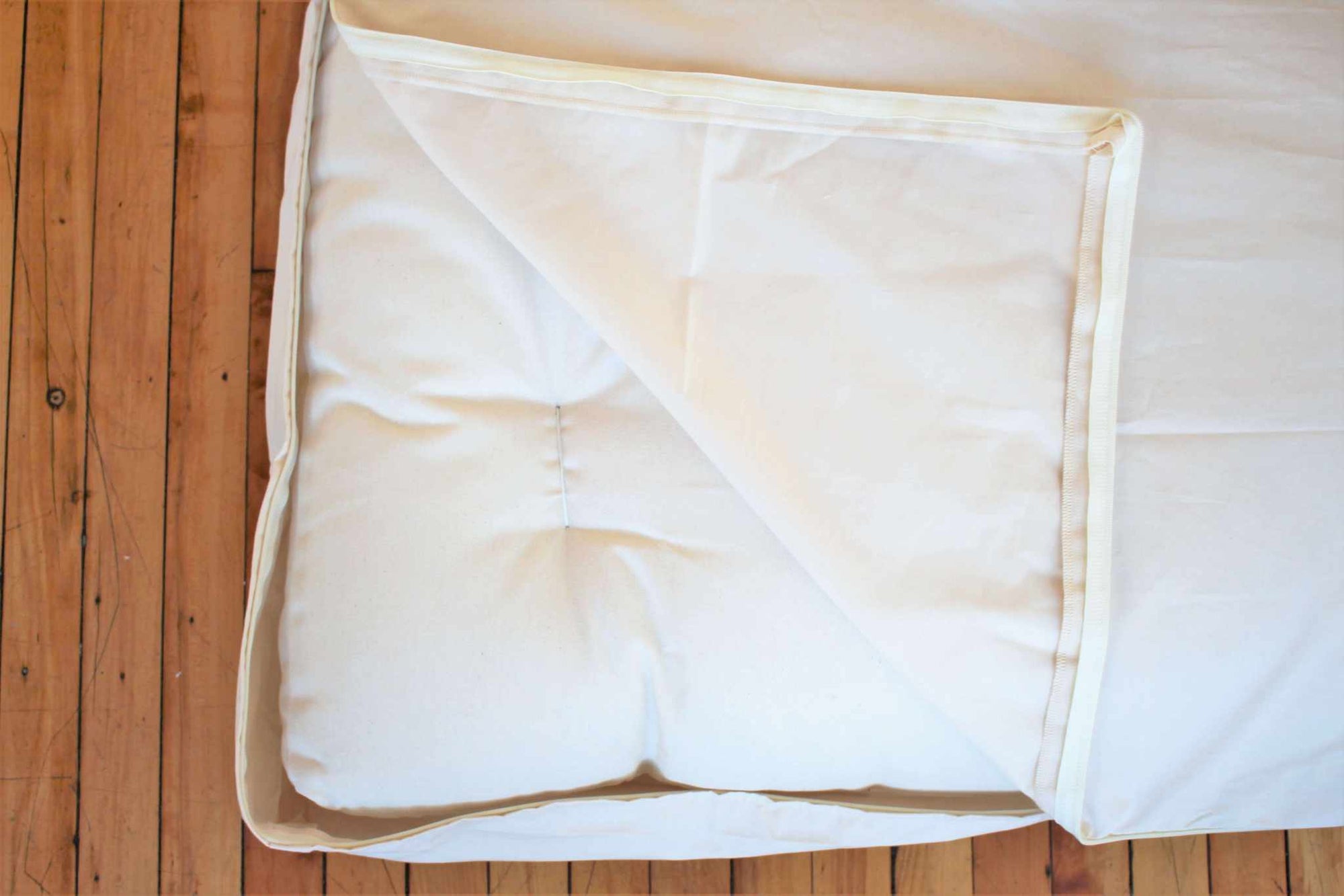 Organic cotton waterproof mattress protector zipper detail showing natural fabric texture