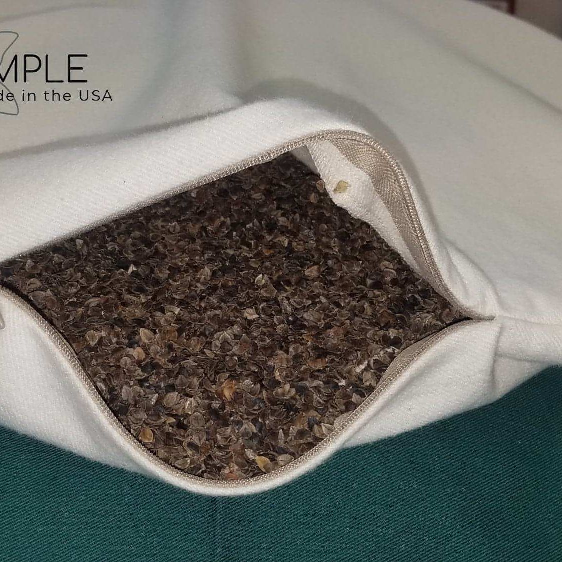 Organic buckwheat pillow with adjustable zipper for customizable comfort and support.