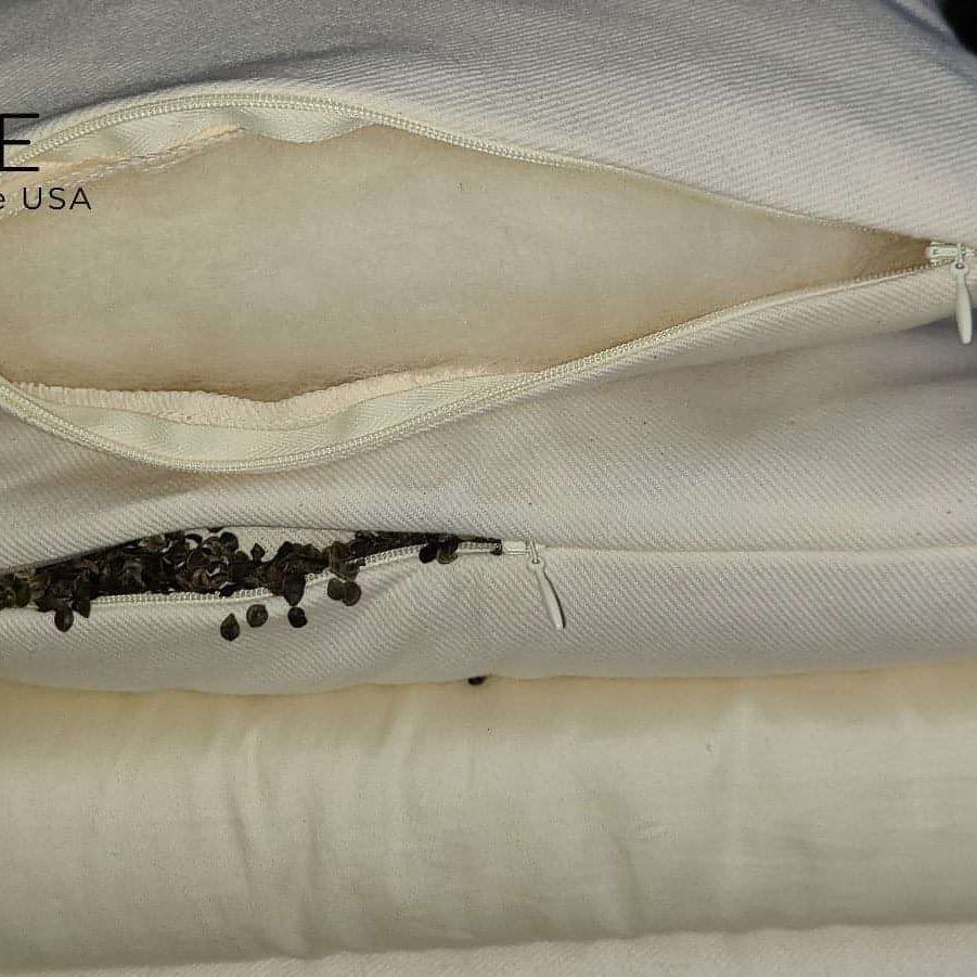 Buckwheat and wool pillow showing inner materials with zippers open, highlighting organic and breathable features.