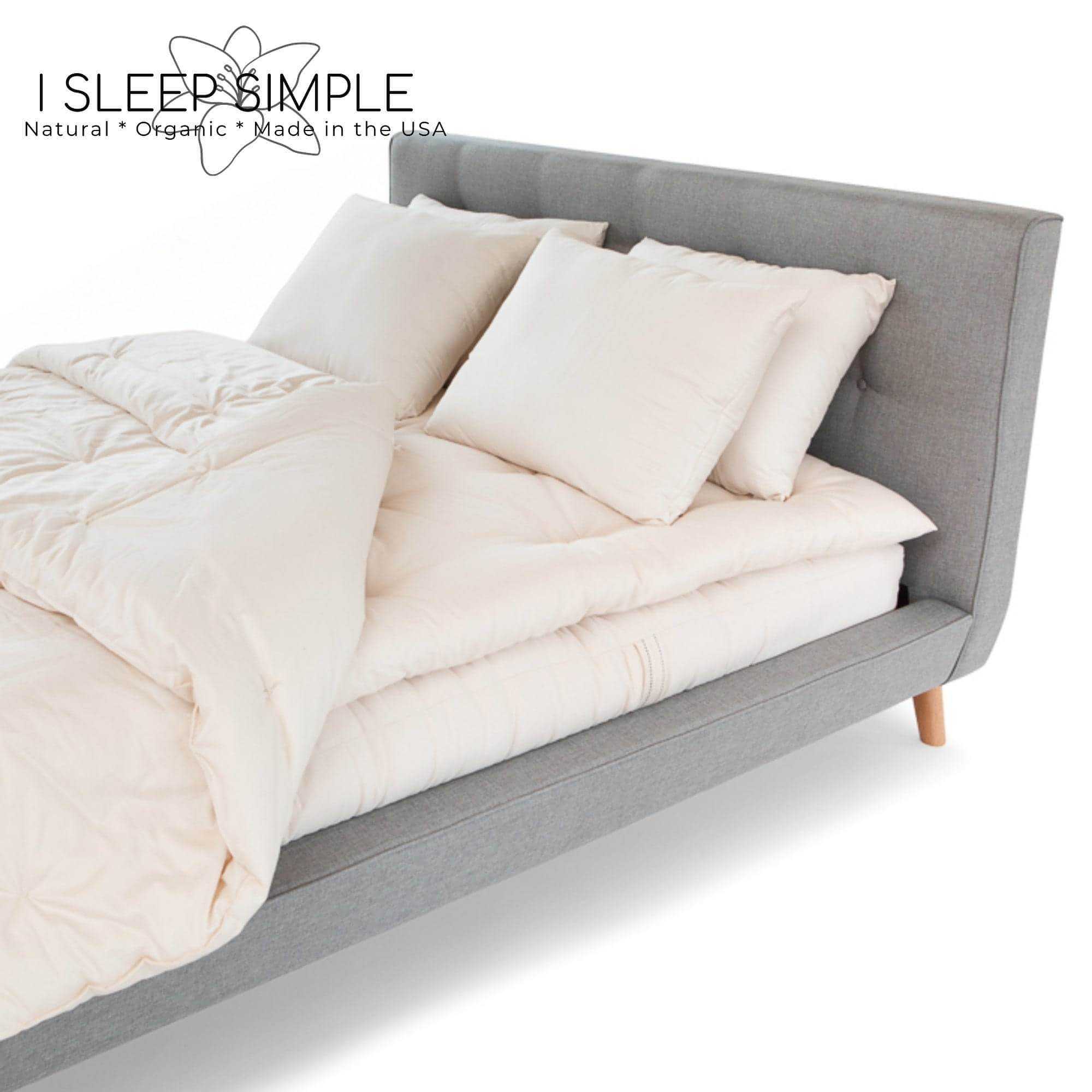 Kapok pillow on a modern grey bed, showcasing soft, sustainable, eco-friendly comfort for all sleeping positions.