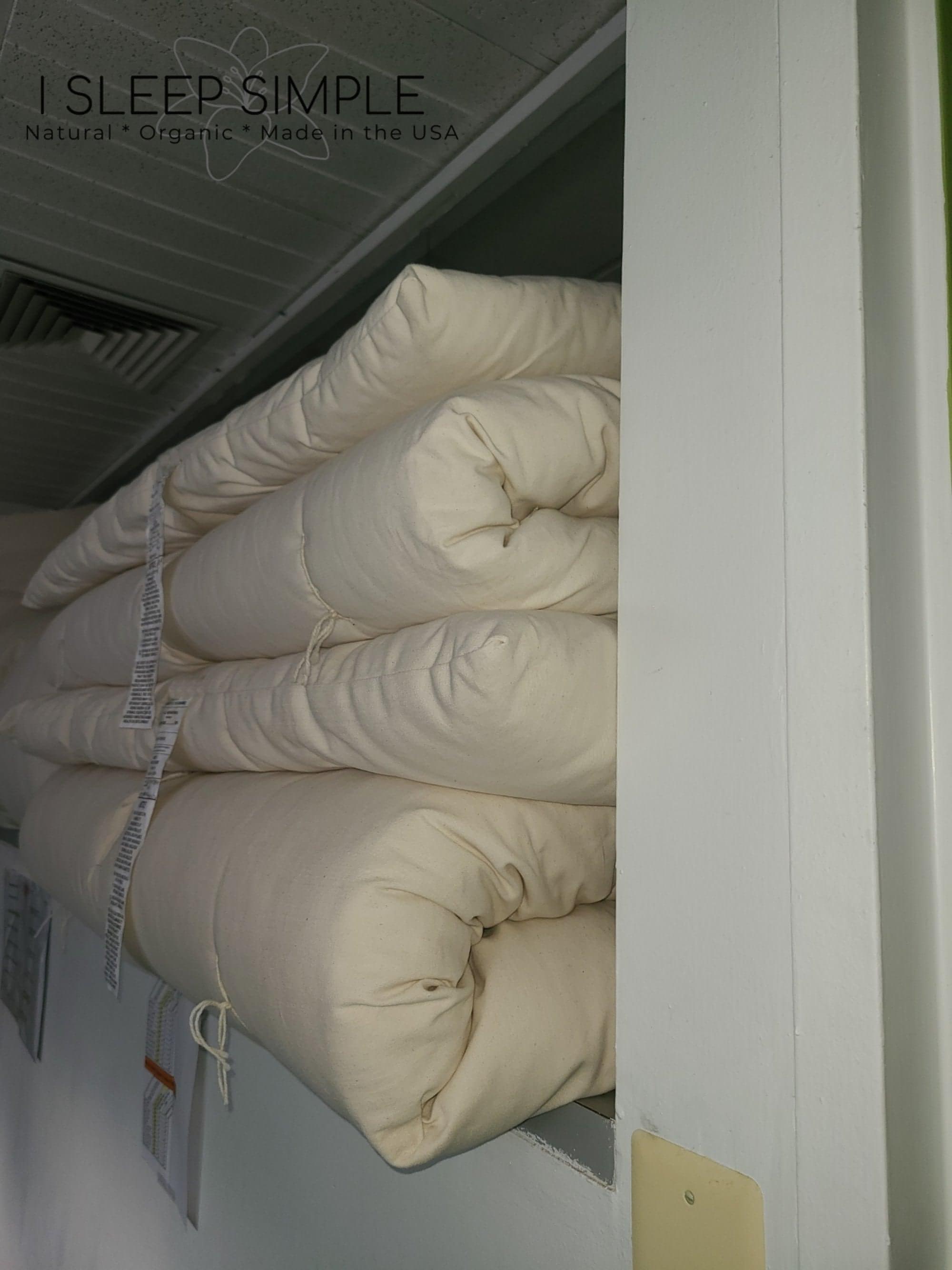 Cotton mattress topper stacked, handmade in USA, available in 2&quot; and 4&quot; thickness for plush comfort.