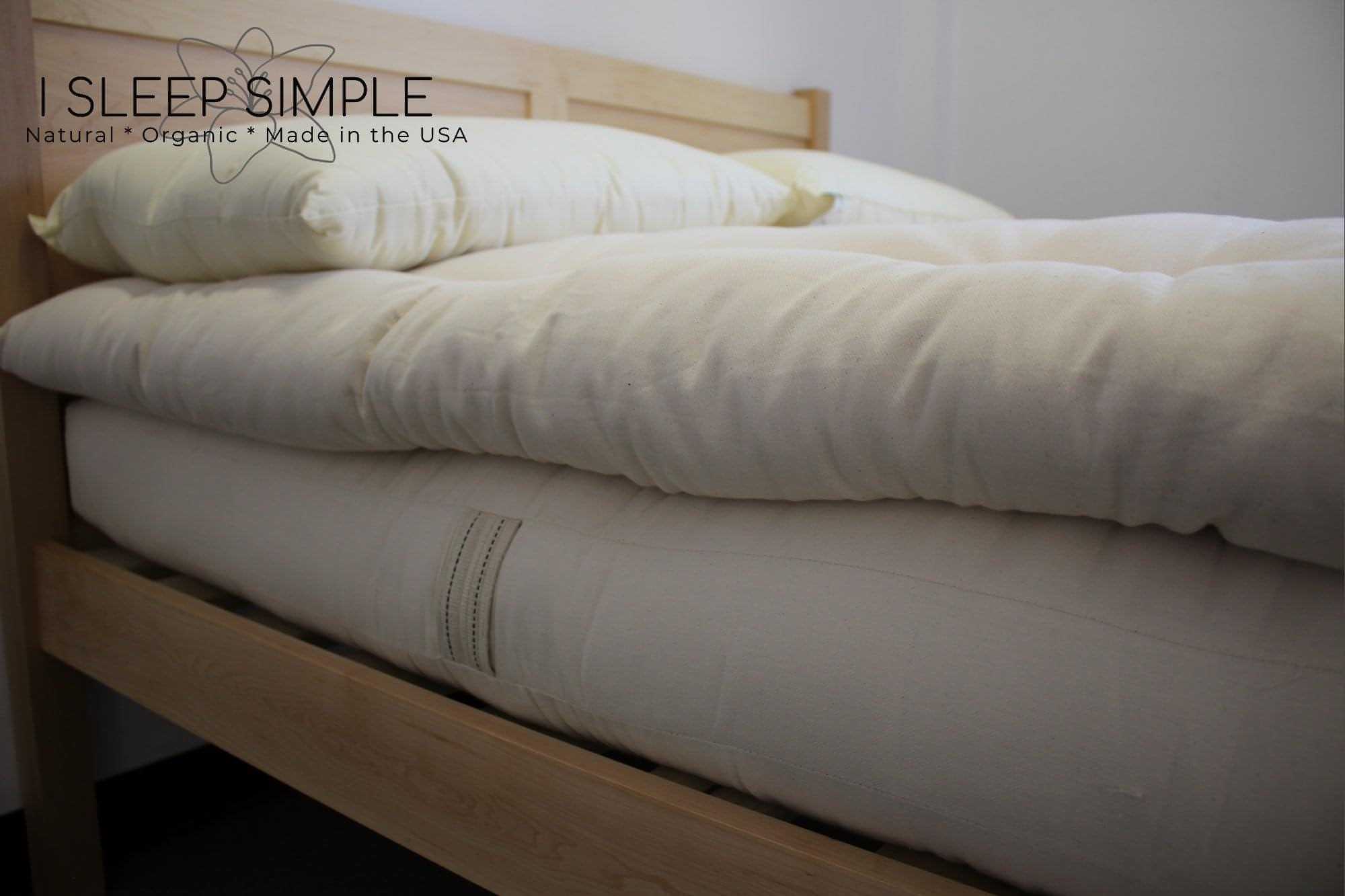 Organic cotton mattress topper on a bed for natural plush comfort.