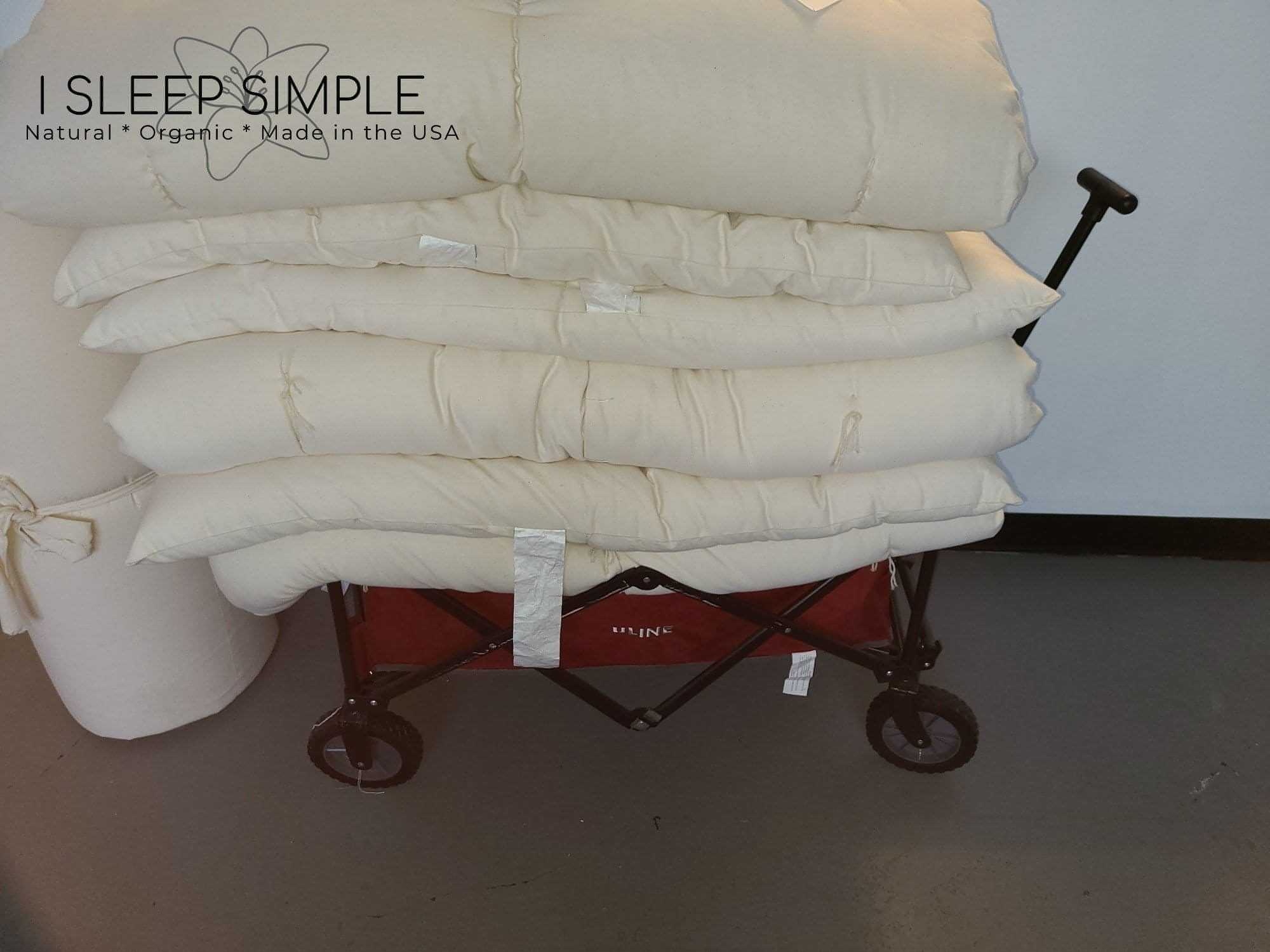 GOTS Certified Organic Topper made of cotton stacked on a wagon.