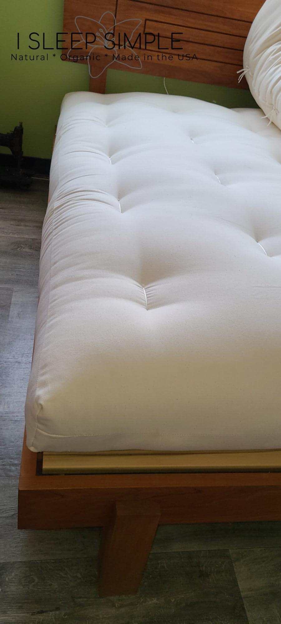 GOTS certified organic cotton and wool futon mattress on wooden frame.