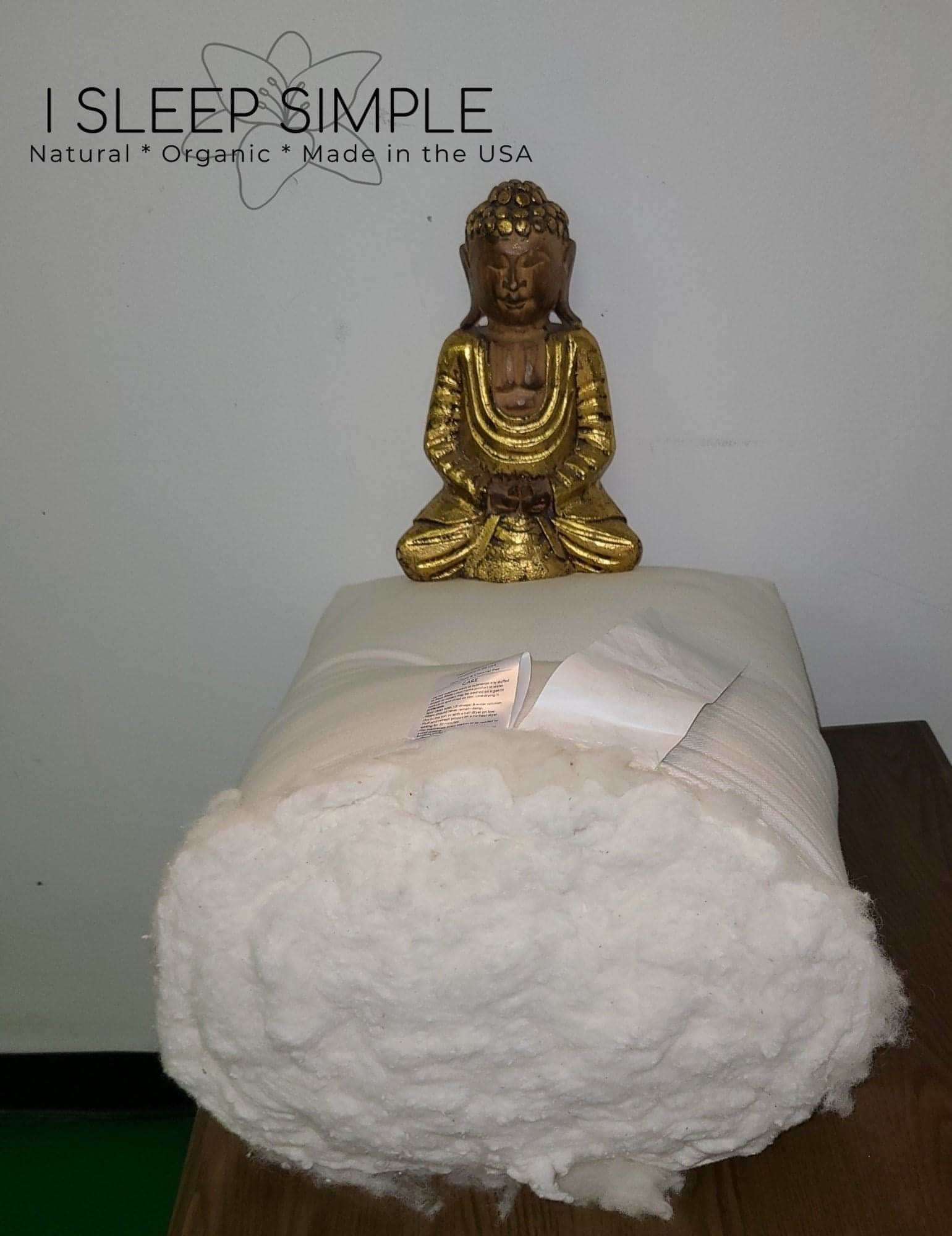 Organic cotton and wool futon mattress roll with Buddha statue.