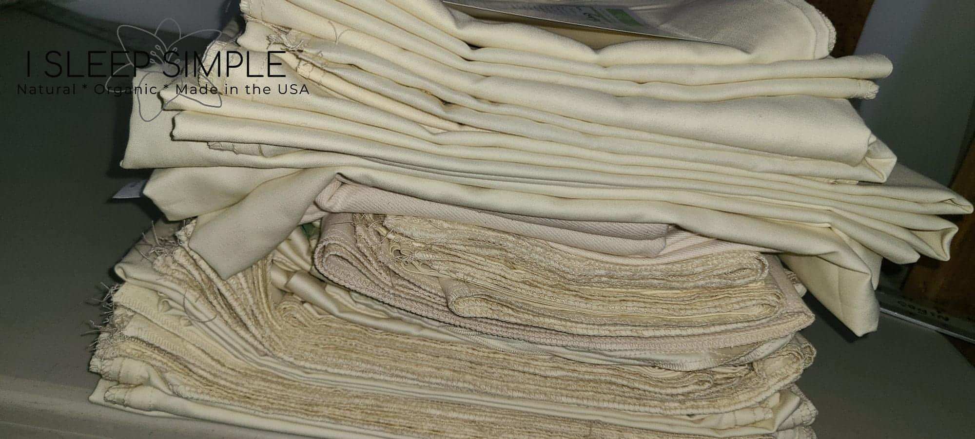 Stack of folded organic pillowcases with natural fabric and texture, made in the USA.