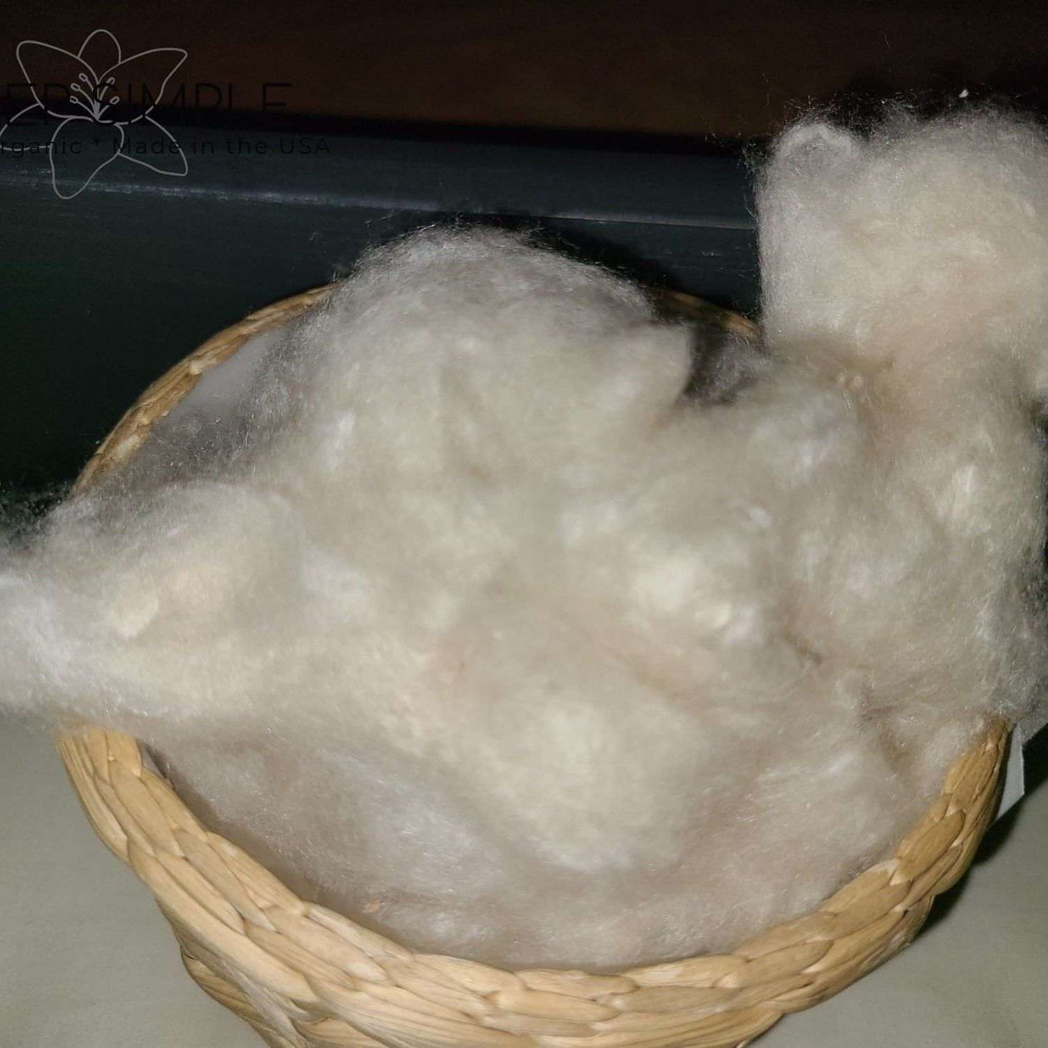 Natural kapok fiber in a basket, ideal for pillows and cushions, eco-friendly and vegan.