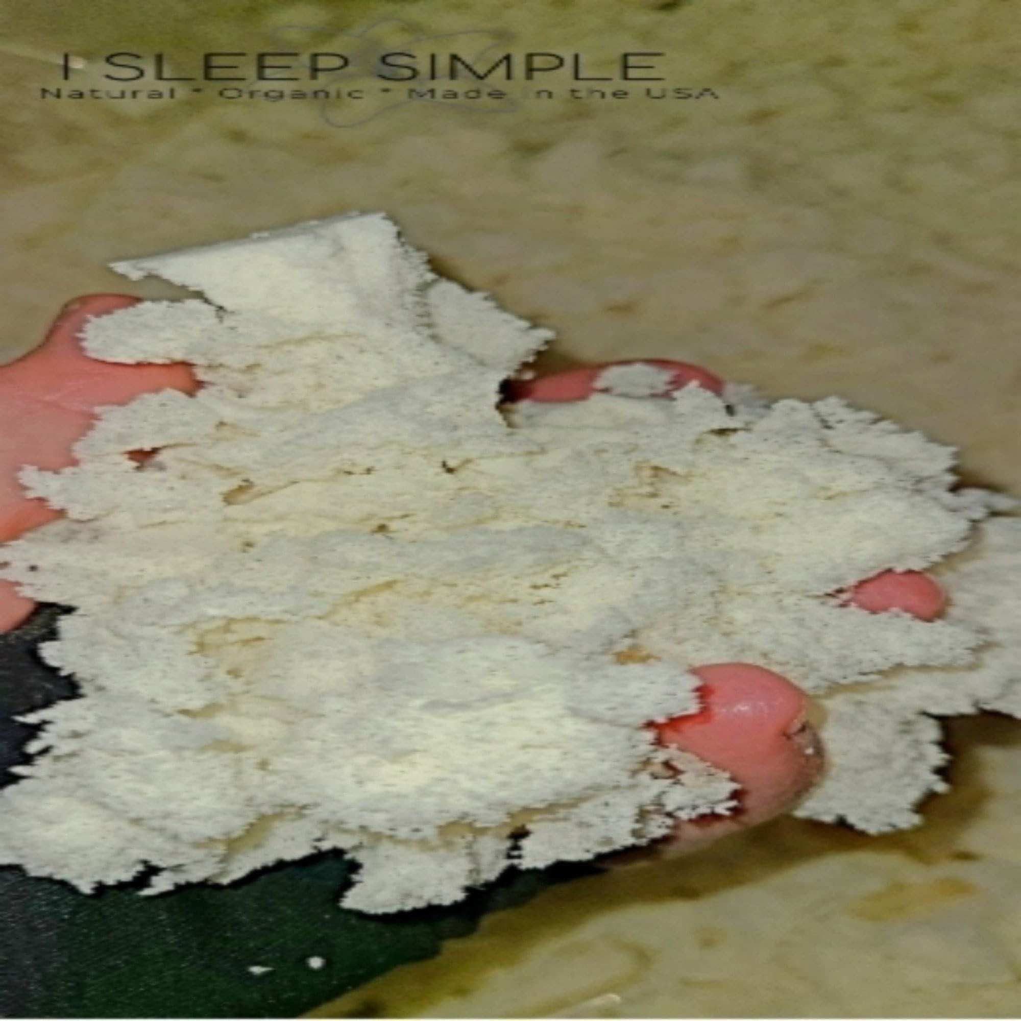 Natural Shredded Latex Fill, shown in hand. Ideal for pillows, cushions &amp; beanbags, made in the USA.