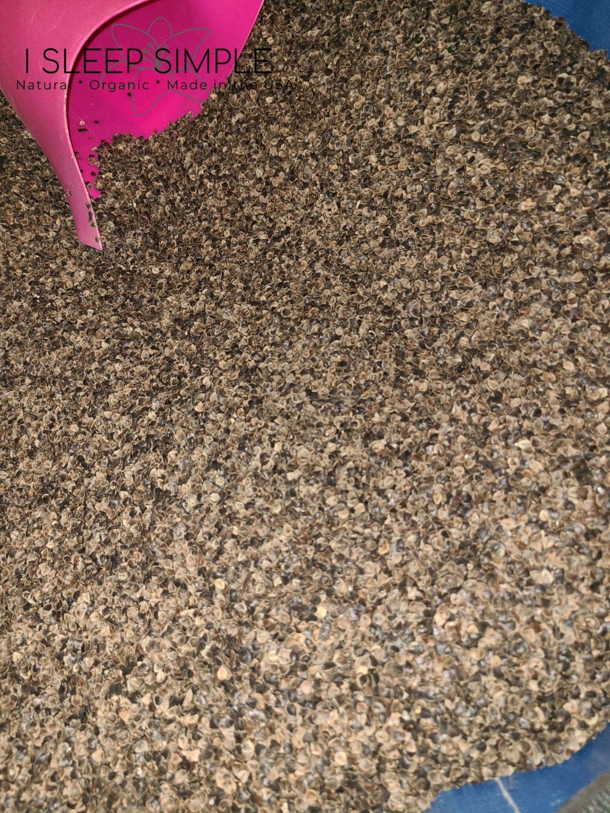 Organic buckwheat hulls from the US in a pink scoop, ideal for pillows and cushions.